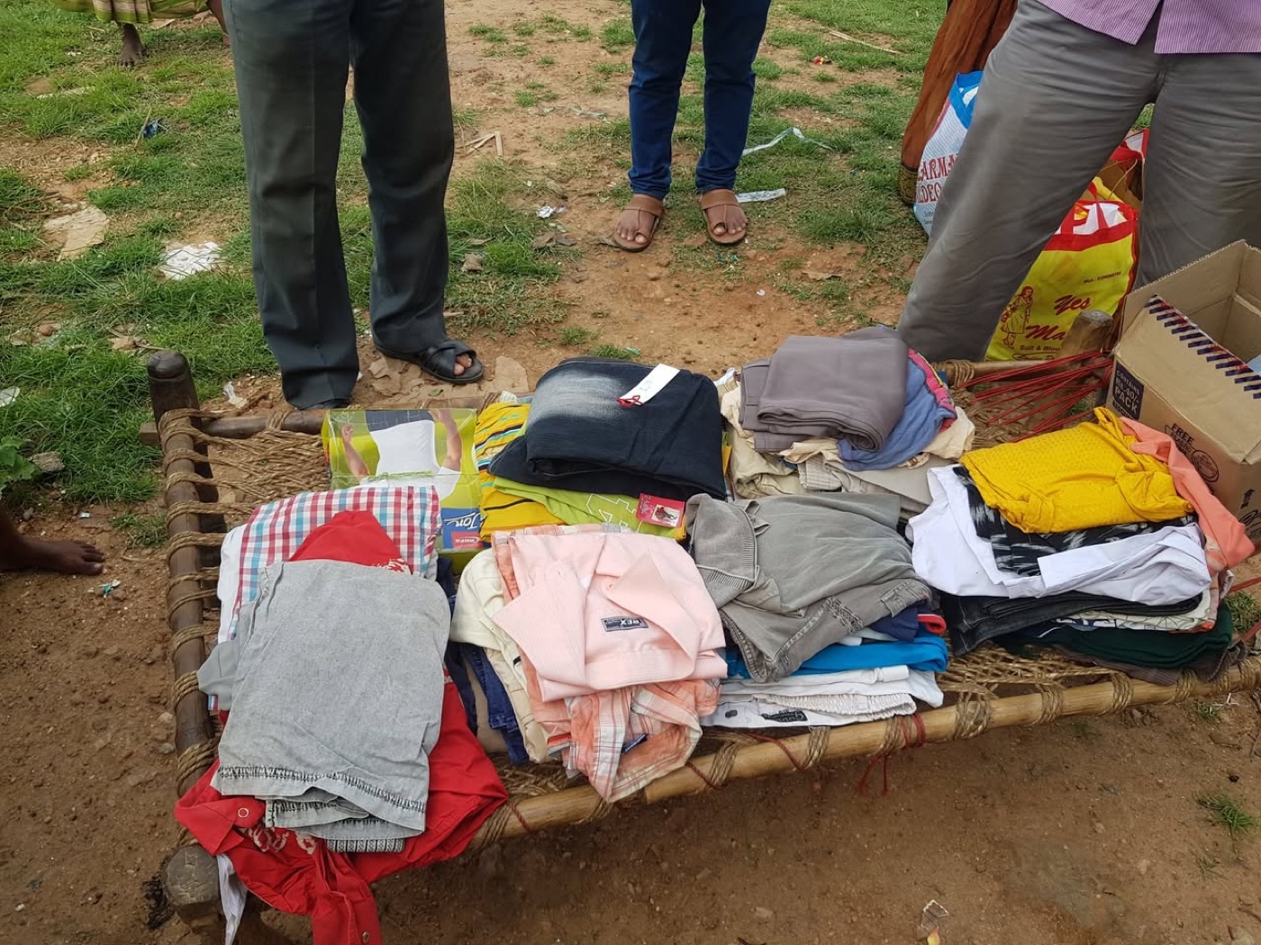 Folded sets of clothes laid out for distribution