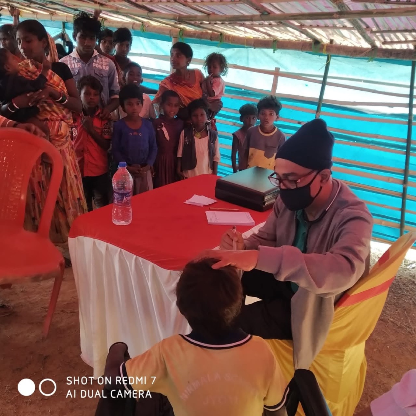 A doctor examining children at a free medical camp at Begula Basti