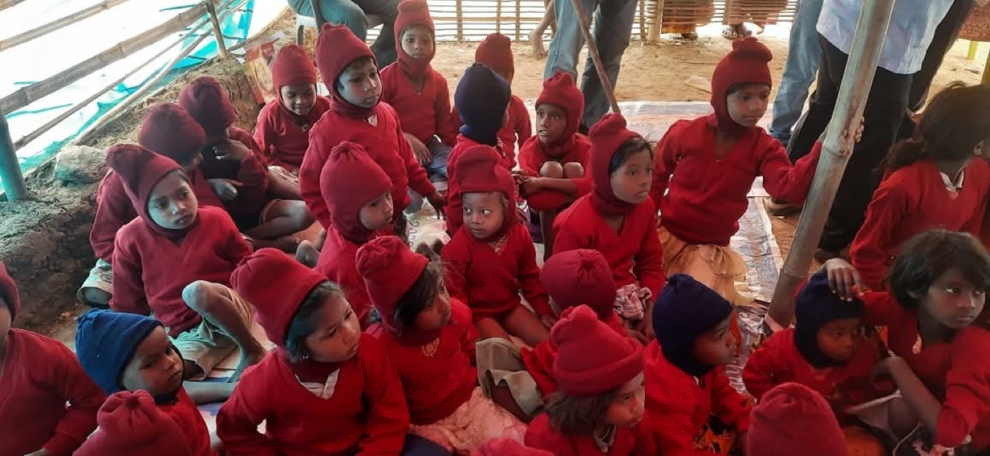 A group of children in warm red clothes at the supported slum school